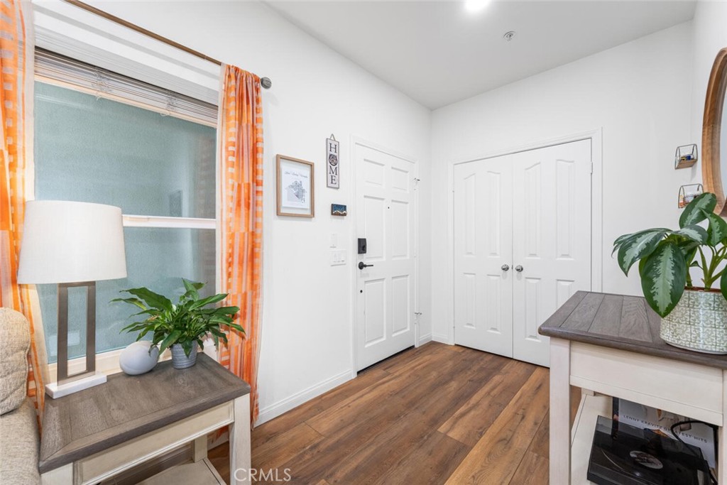 1516 Pacific Coast Highway, Unit 101 Huntington Beach, CA 92648 - Photo 7 of 58 a view of a hallway with wooden floor and a potted plant