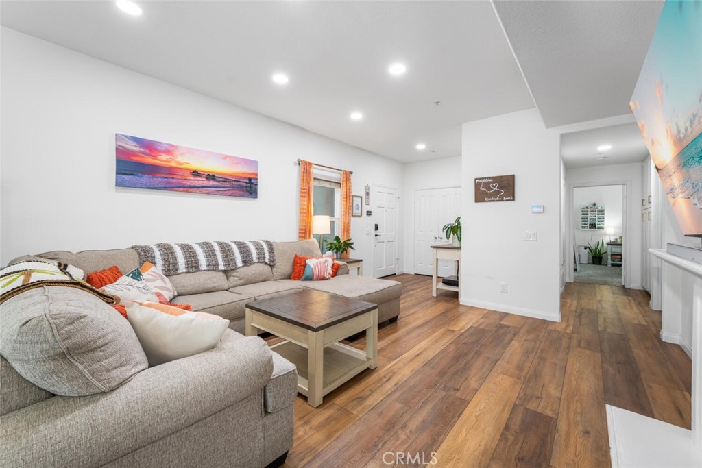 1516 Pacific Coast Highway, Unit 101 Huntington Beach, CA 92648 - Photo 8 of 58 a living room with furniture and wooden floor
