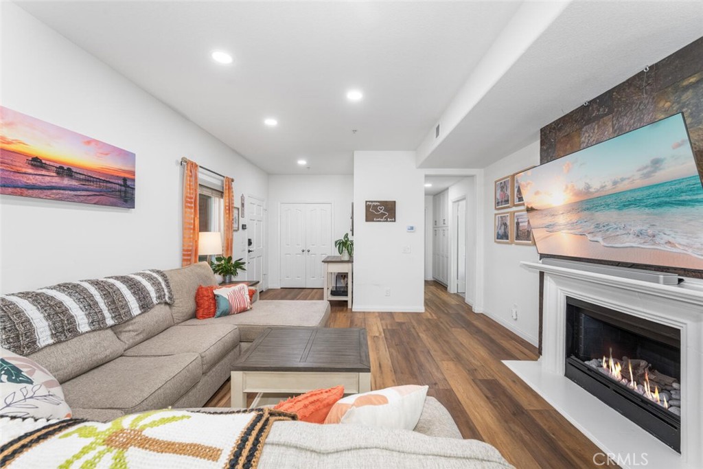1516 Pacific Coast Highway, Unit 101 Huntington Beach, CA 92648 - Photo 9 of 58 a living room with furniture and a fireplace
