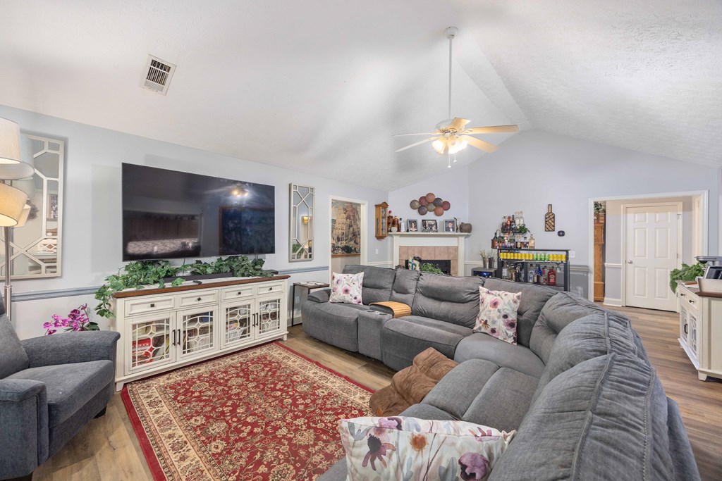 2083 Johnson Mill Road Hamilton, GA 31811 - Photo 13 of 54 a living room with furniture a flat screen tv and a chandelier