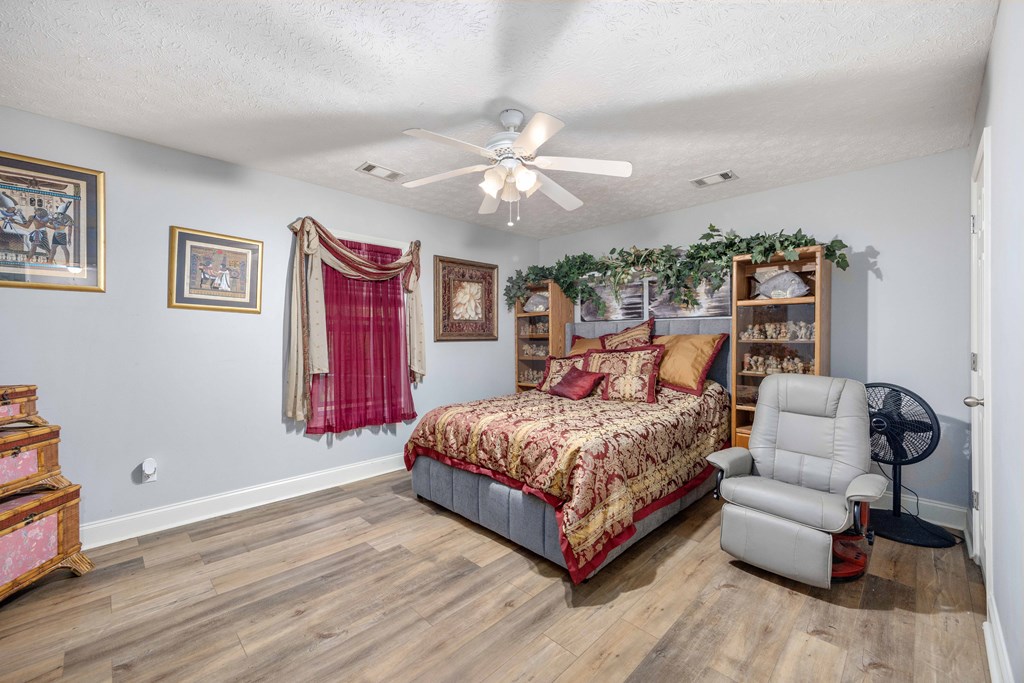 2083 Johnson Mill Road Hamilton, GA 31811 - Photo 16 of 54 a bedroom with a bed couch and window