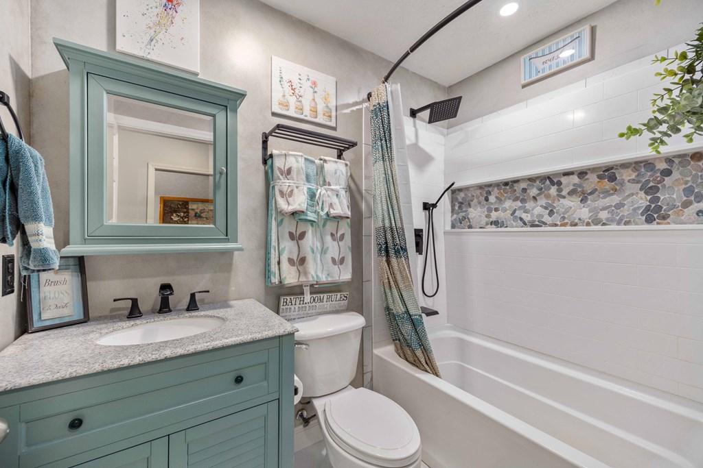 2083 Johnson Mill Road Hamilton, GA 31811 - Photo 17 of 54 a bathroom with a granite countertop toilet sink and a mirror