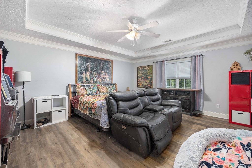 2083 Johnson Mill Road Hamilton, GA 31811 - Photo 19 of 54 a spacious bedroom with a bed couch and a window