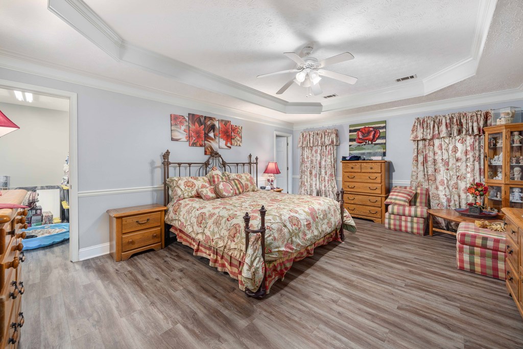 2083 Johnson Mill Road Hamilton, GA 31811 - Photo 22 of 54 a bedroom with a bed and wooden floor