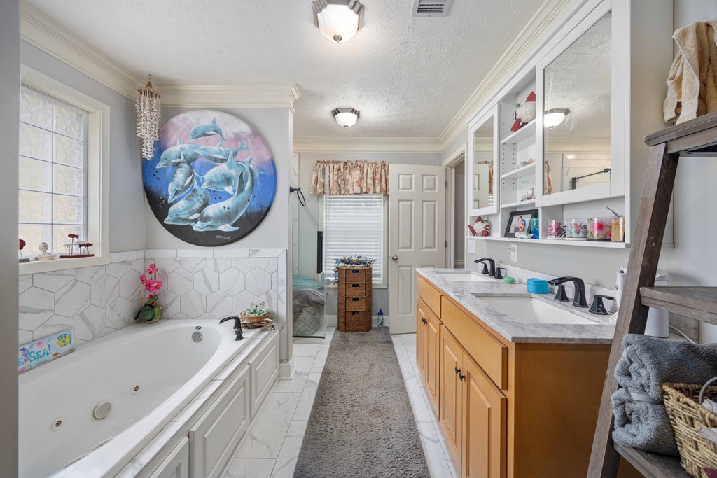 2083 Johnson Mill Road Hamilton, GA 31811 - Photo 26 of 54 a bathroom with a tub sink a mirror and a shower