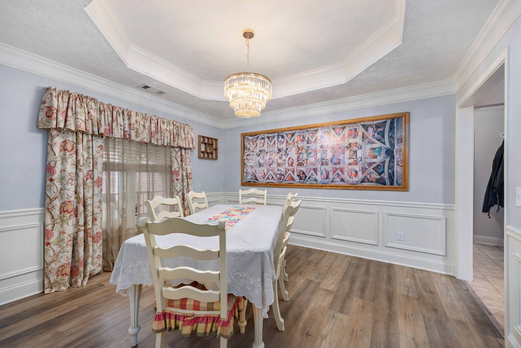 2083 Johnson Mill Road Hamilton, GA 31811 - Photo 4 of 54 a view of a dining room with furniture wooden floor and a chandelier