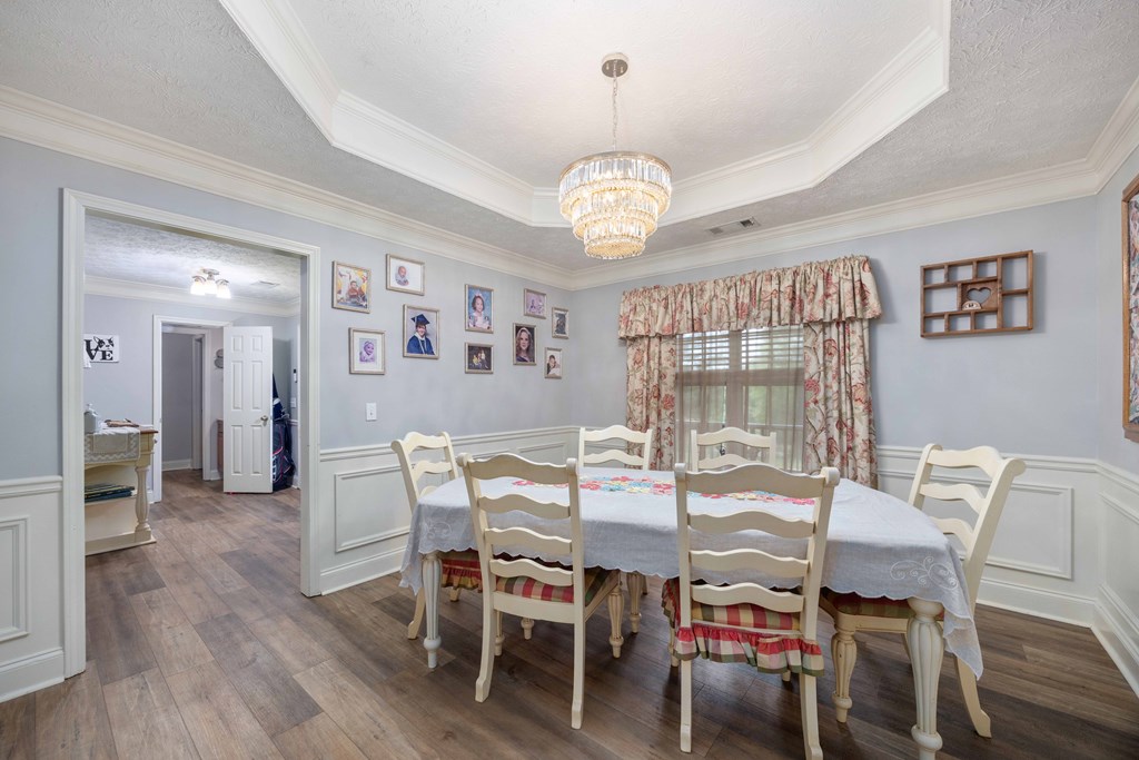 2083 Johnson Mill Road Hamilton, GA 31811 - Photo 5 of 54 a view of a dining room with furniture wooden floor and chandelier