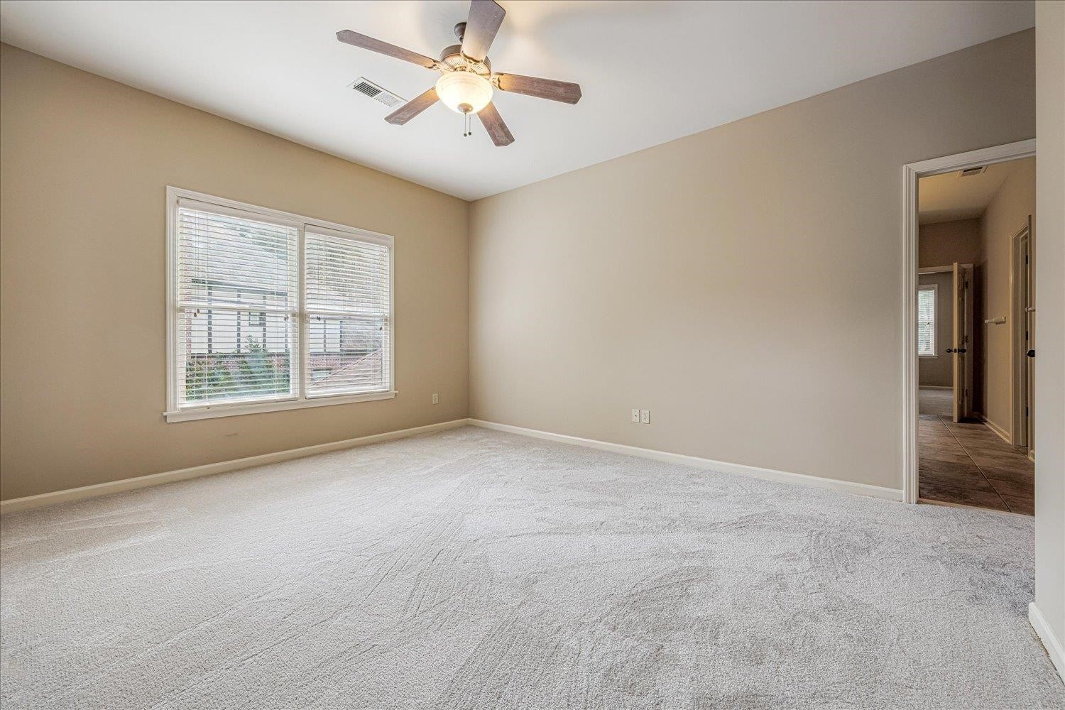 4597 Whisper Spring Drive Collierville, TN 38017 - Photo 27 of 39 an empty room with windows and fan