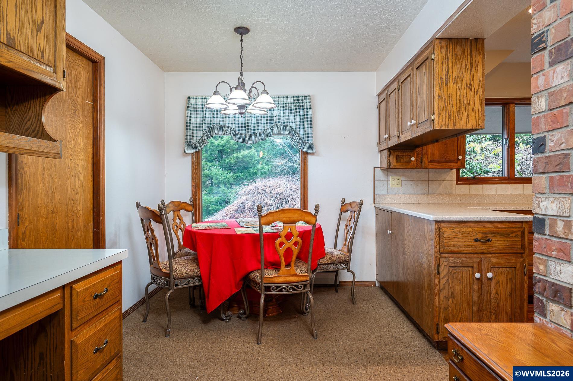27572 South Kinzy Road Estacada, OR 97023 - Photo 17 of 50 a dining room with furniture a chandelier and window