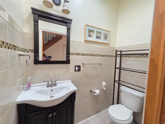 a bathroom with a sink toilet and mirror