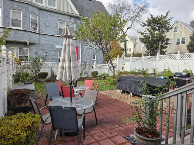 a view of backyard with outdoor seating and plants