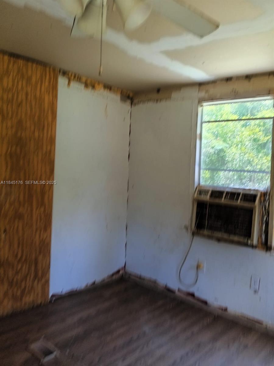147 2nd Way Interlachen, FL 32148 - Photo 14 of 28 an empty room with wooden floor and windows