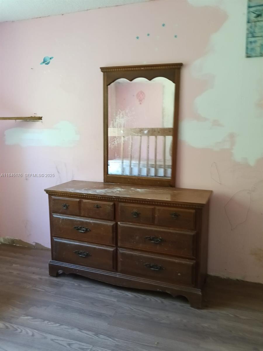 147 2nd Way Interlachen, FL 32148 - Photo 22 of 28 a room with wooden floor and a window