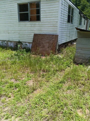 a side view of a house with a yard