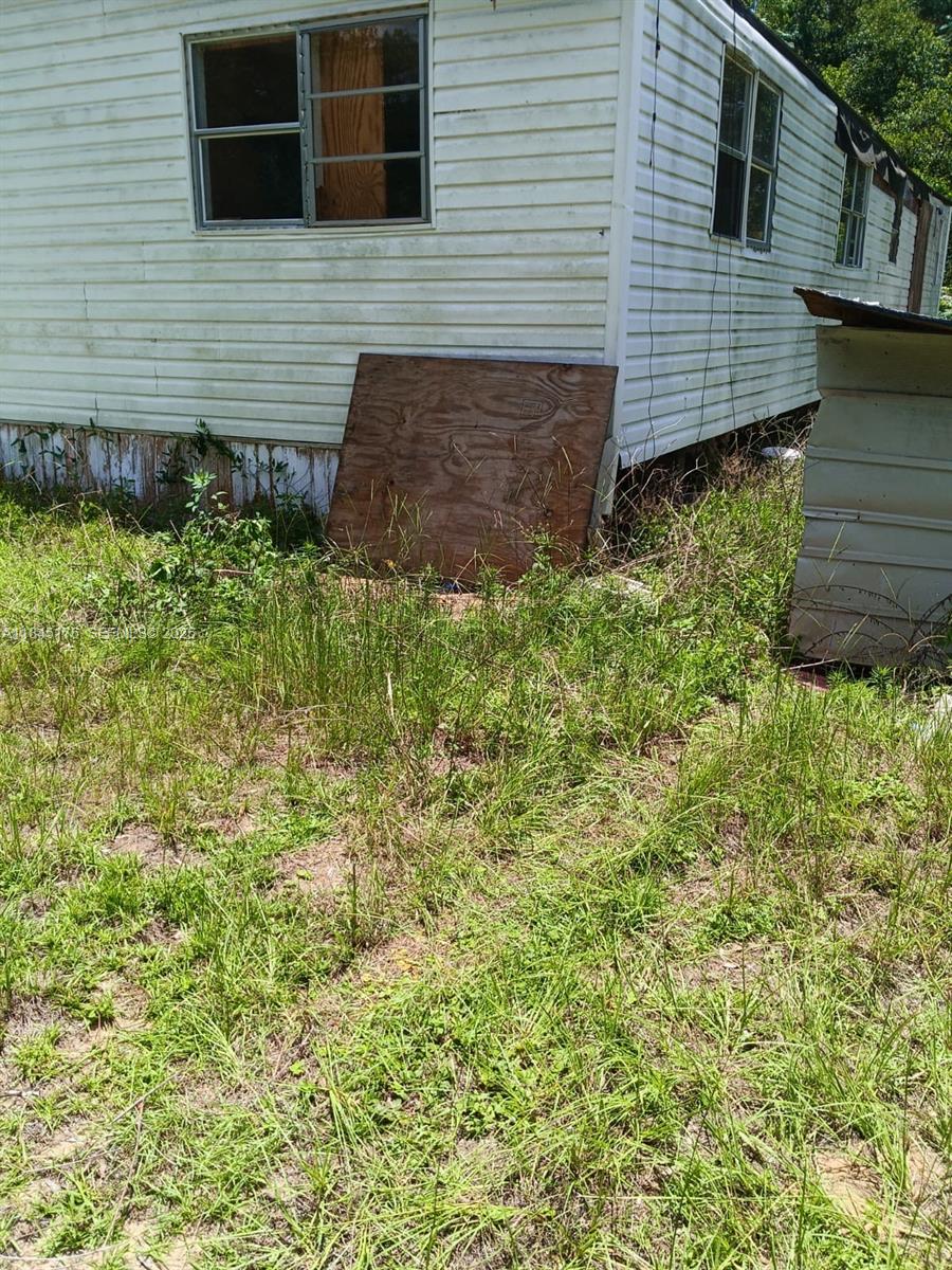 147 2nd Way Interlachen, FL 32148 - Photo 23 of 28 a view of brick house with a yard