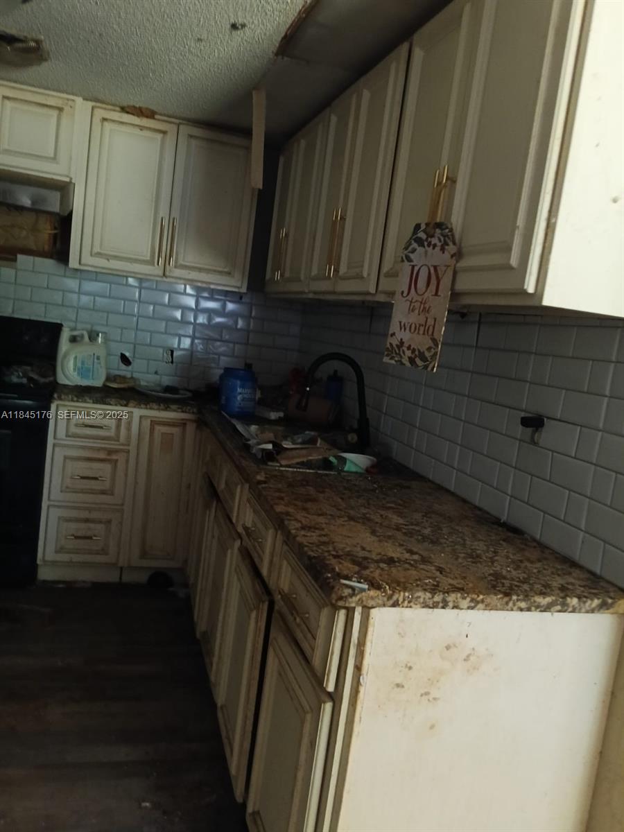 147 2nd Way Interlachen, FL 32148 - Photo 3 of 28 a kitchen with granite countertop a sink stove and cabinets
