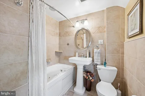 a bathroom with a toilet a sink and a bathtub