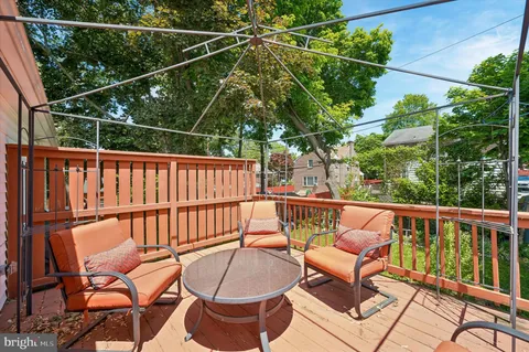 a view of a chairs and tables in the roof deck