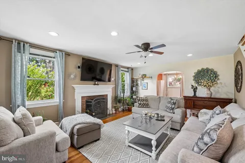 a living room with furniture fireplace and flat screen tv
