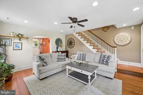 a living room with furniture and a clock