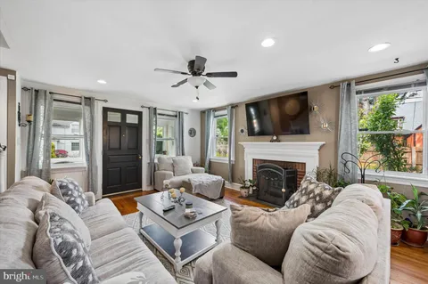a living room with furniture a fireplace and a flat screen tv