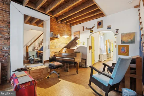a living room with furniture a rug and a window