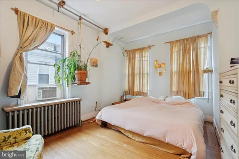 a bedroom with a bed and a chair