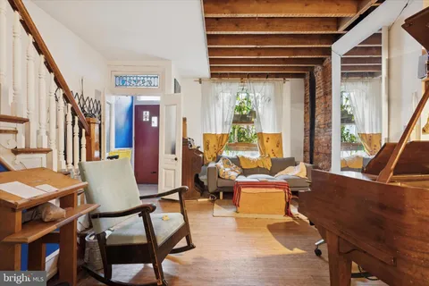 a living room filled with furniture and a window
