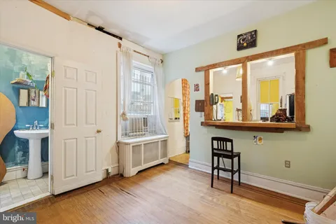 a bathroom with a sink mirror and toilet