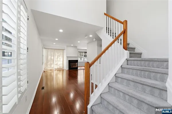 a view of entryway and hall with wooden floor