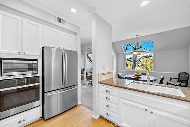 a kitchen with appliances a counter space and a window