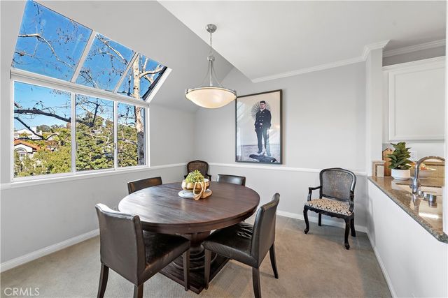 a view of a dining room with a table and chairs