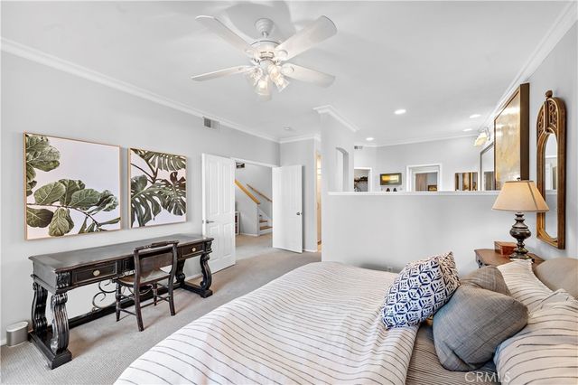 a bedroom with furniture and a large window
