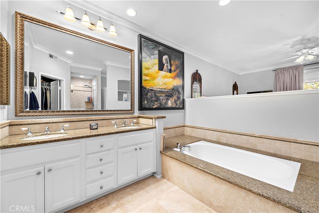 a bathroom with a tub sink and mirror