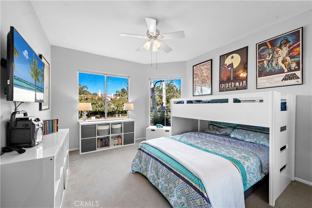 a spacious bedroom with a bed and a chandelier