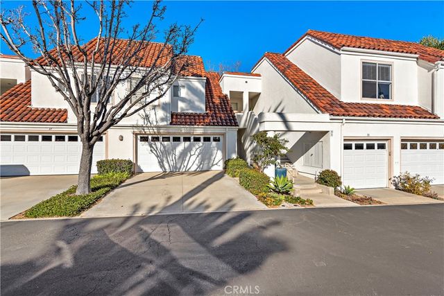 a view of a house with snow on the road