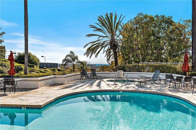a view of swimming pool with outdoor seating and plants