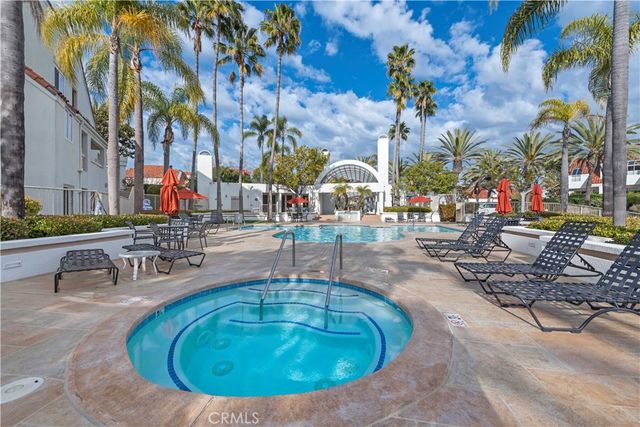 a view of a swimming pool with outdoor seating