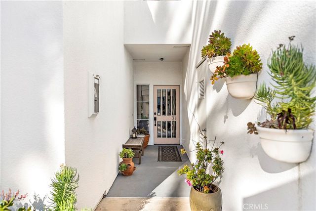 a vase of flowers sitting on a floor