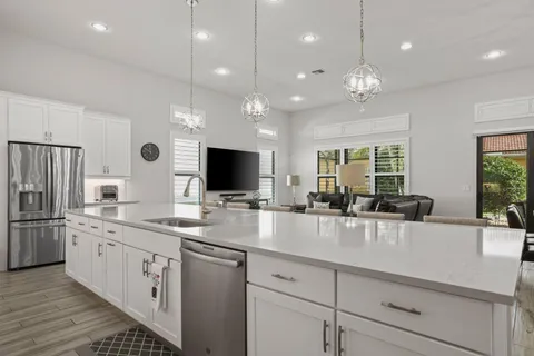 a living room with lots of furniture and kitchen view
