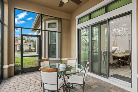 a living room with stainless steel appliances kitchen island granite countertop a stove and a sink