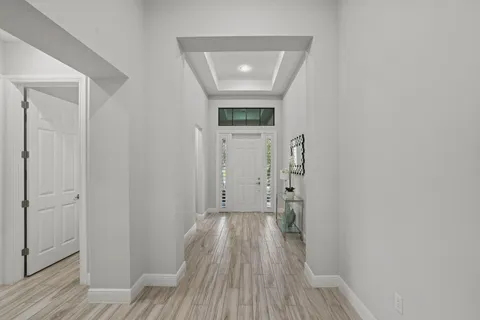 a large white kitchen with stainless steel appliances granite countertop a sink a stove and a refrigerator