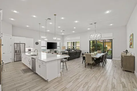 a kitchen with counter top space a sink stainless steel appliances and cabinets