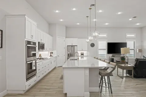 a kitchen with stainless steel appliances a refrigerator and microwave