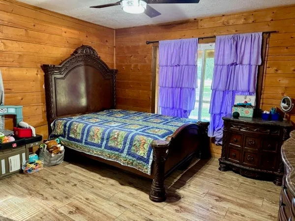 a bed sitting in a bedroom next to a window