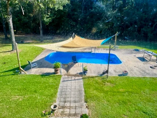 a view of a wooden deck with chairs and a yard