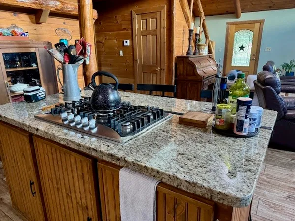 a view of a kitchen with chair and wooden floor