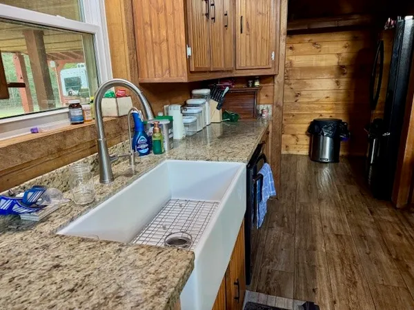 a kitchen with stainless steel appliances granite countertop a stove and a wooden cabinets