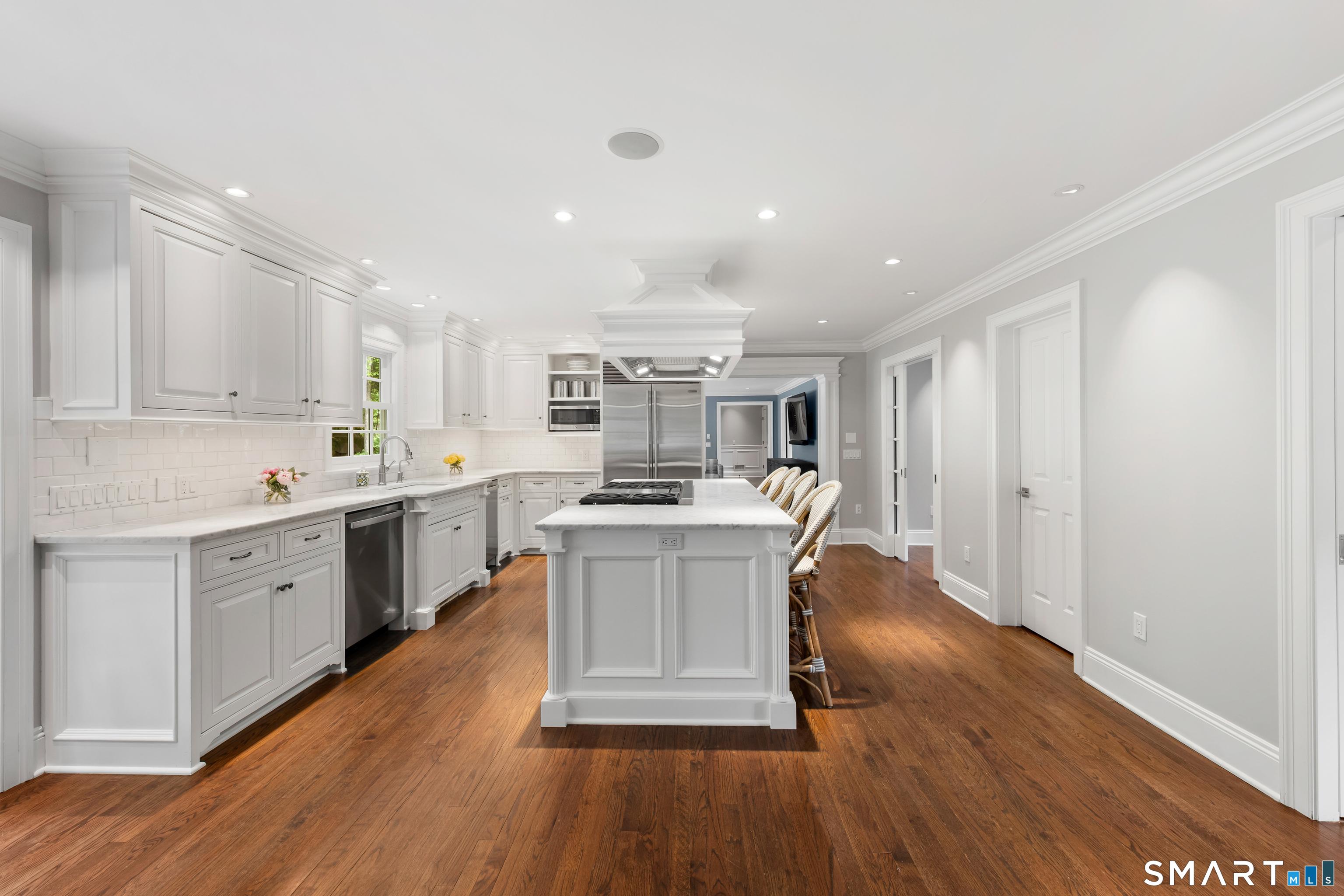 99 Hickok Road New Canaan, CT 06840 - Photo 8 of 39 a kitchen with a sink window and wooden floor