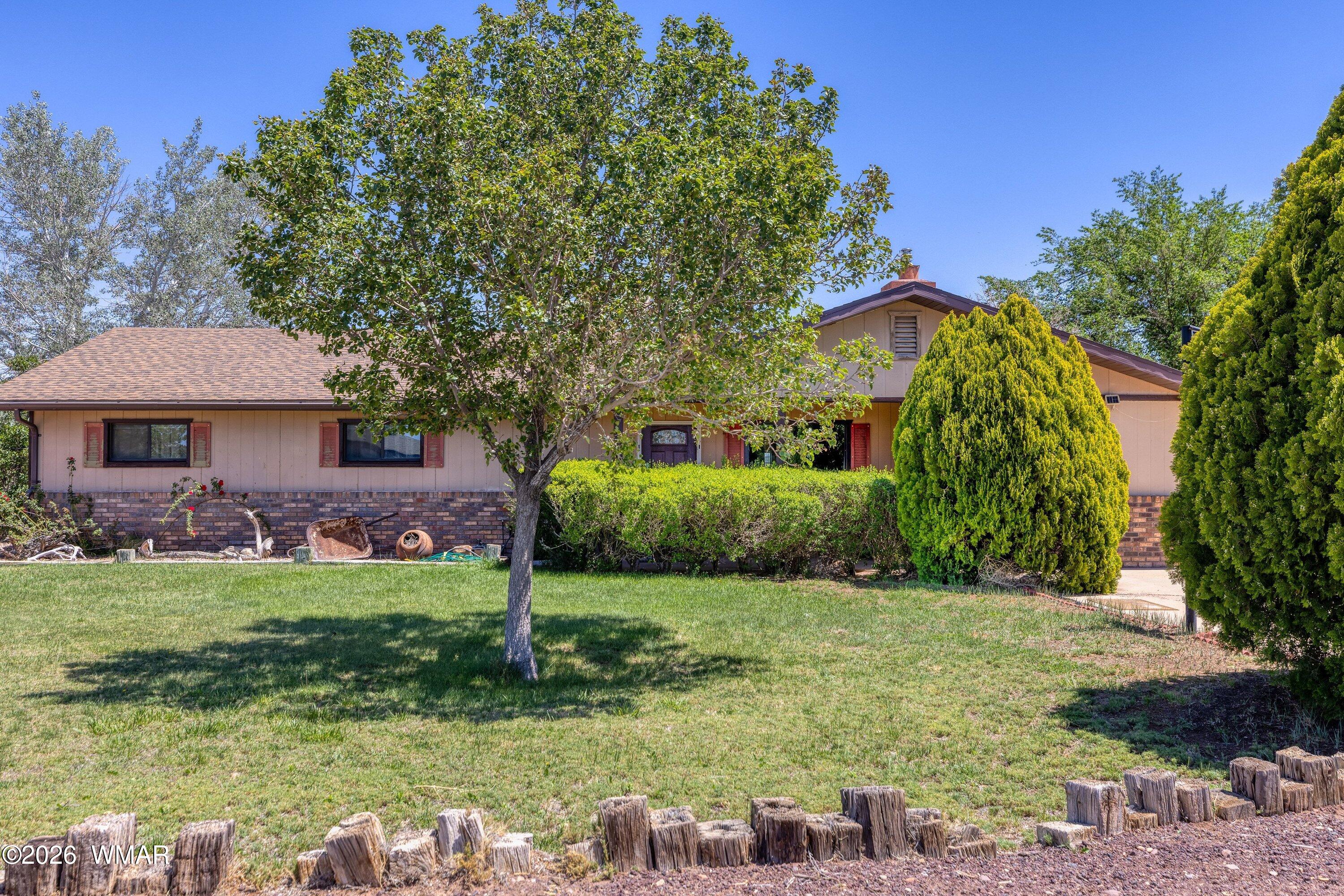 1114 Ranch Road Taylor, AZ 85939 - Photo 2 of 32 a front view of a house with garden